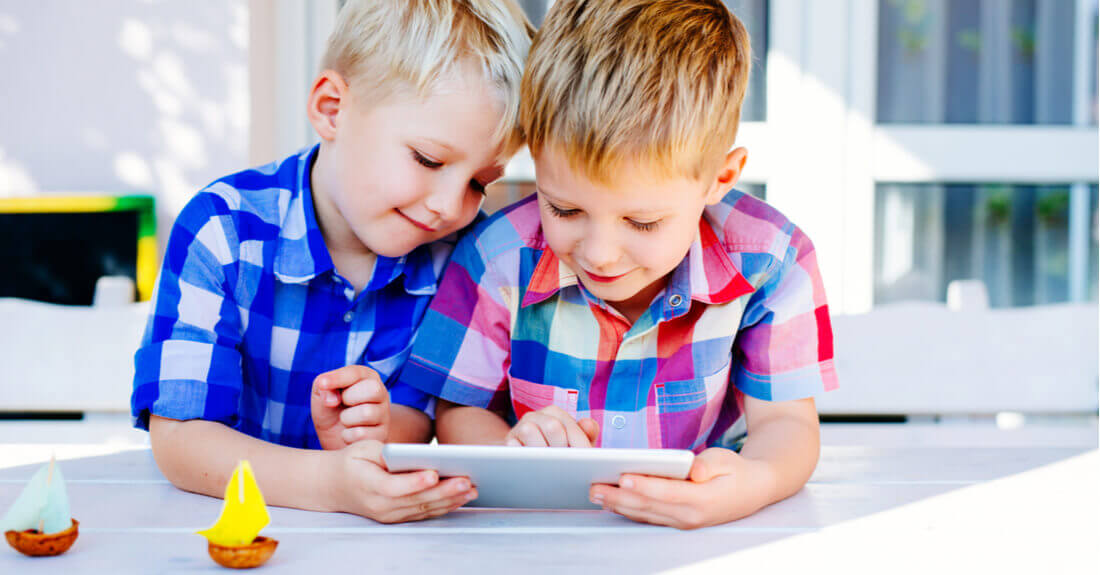 Children on a terrace with a tablet